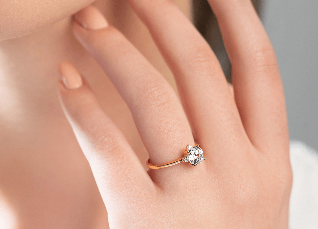 Krupni plan ženske ruke s prekrasnim dijamantnim prstenom.